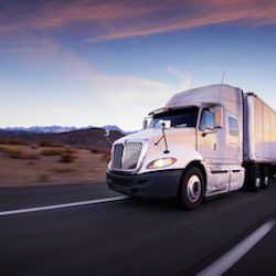 Truck and highway at sunset - transportation background